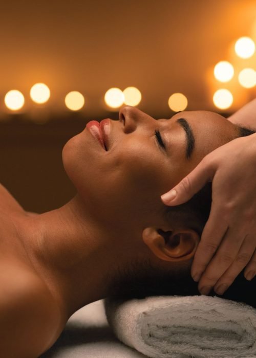 woman receiving a soothing head massage at a premium spa in Virginia Beach for ultimate relaxation